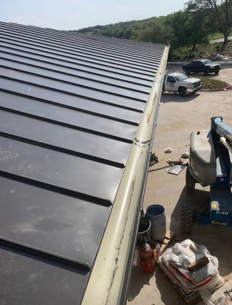 Standing seam panel and gutter detail on a metal roofing jobsite in Buena Park